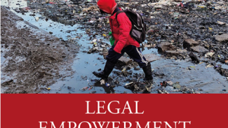 Title page of the publication 'Legal Empowerment in Informal Settlements', above the title on a red background is an image of a child in a red rain jacket walking across an unpaved street in an informal settlement